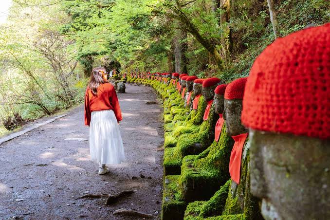 A row of stone Jizo statues lining the Kanmangafuchi Abyss gorge in Nikko