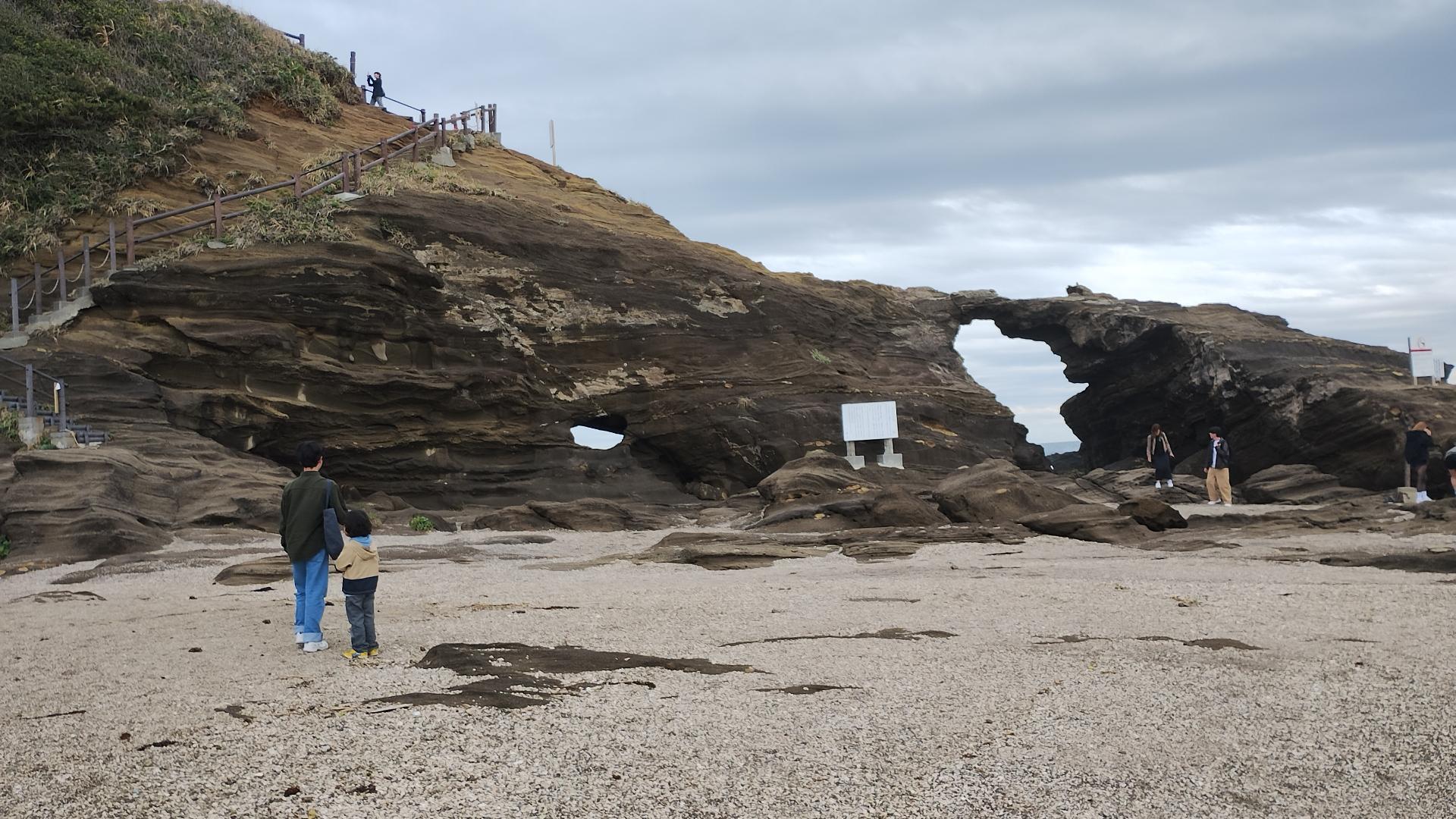 Rugged sea cliffs and small fishing boats along the Miura Peninsula coastline