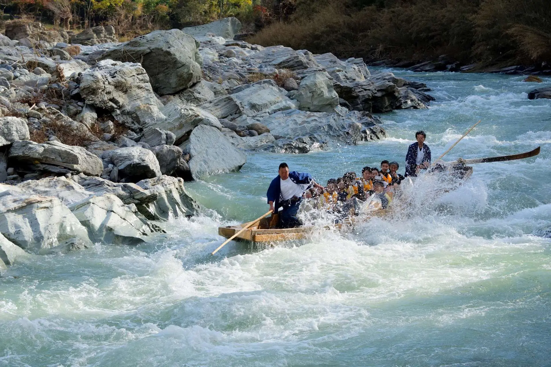 Wooden boat rafting down the rapids of the Nagatoro river gorge past the Iwadatami rock terraces