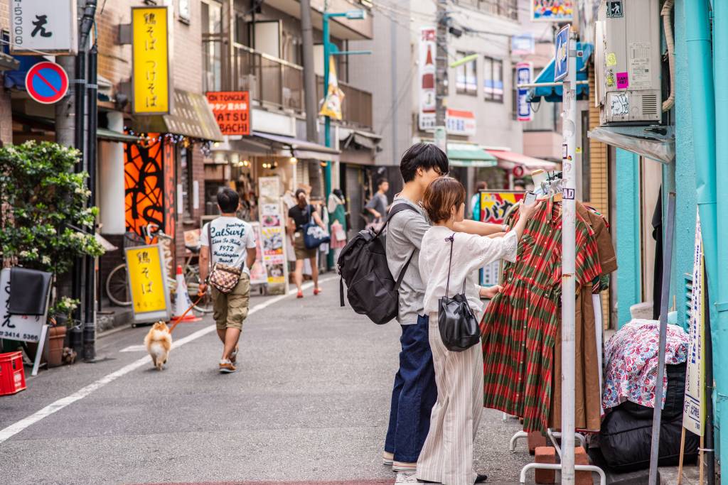 Local shopkeepers calling out to shoppers in a traditional shotengai neighborhood shopping street market in Tokyo