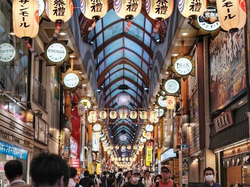Bustling atmosphere inside an old-school covered shotengai market street in a local Tokyo neighborhood