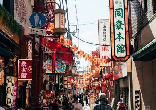 A vibrant, towering red and gold decorative Chinese gate archway