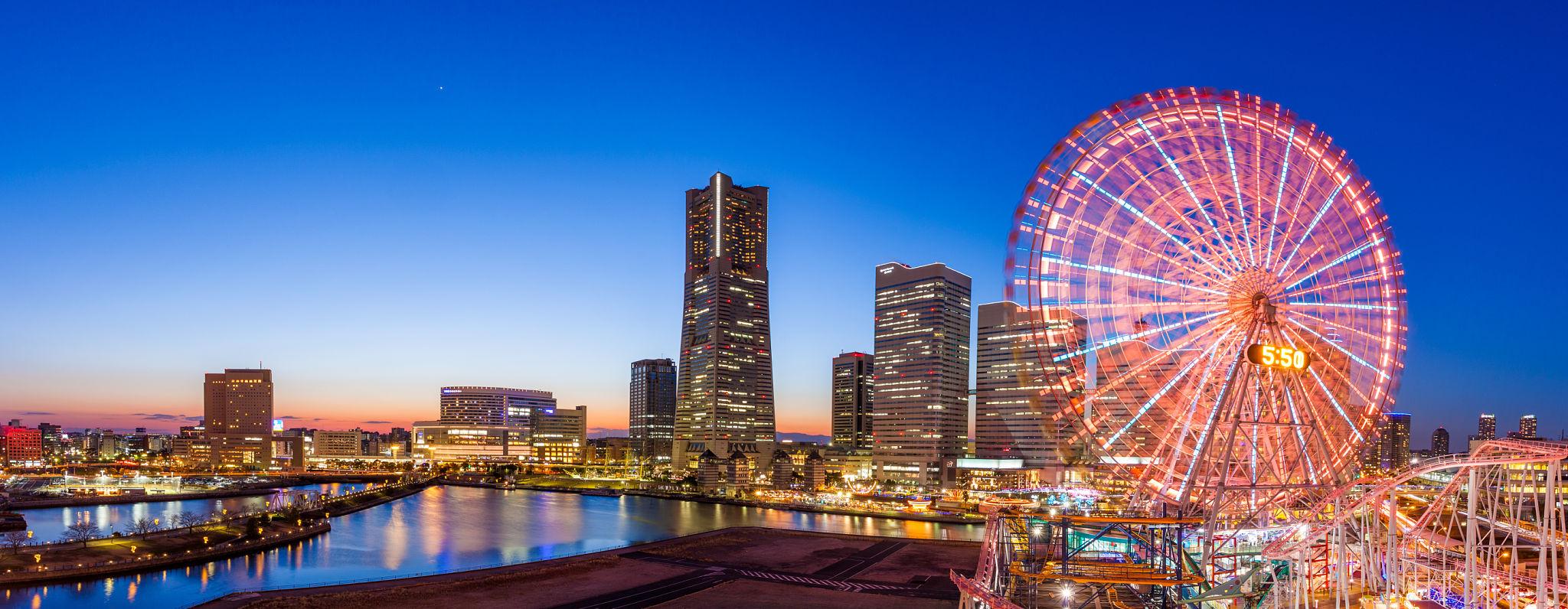 Yokohama's Minato Mirai skyline illuminated at sunset along the waterfront